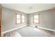 Airy bedroom with dual windows, modern flooring, and minimalist decor at 4210 Main St, Anderson, IN 46013