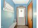 Inviting entryway with a 'Welcome' sign, coat hooks, and a convenient bench at 4210 Main St, Anderson, IN 46013