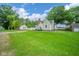 Well-maintained home exterior with a green lawn, mature trees, and a classic architectural style at 4210 Main St, Anderson, IN 46013