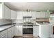 Eat-in kitchen features modern appliances, decorative backsplash and adjacent laundry setup at 4210 Main St, Anderson, IN 46013