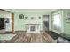 Living room features decor, wood floors, and open access to other living spaces at 4210 Main St, Anderson, IN 46013
