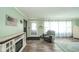 Living room with wood floors, decor, recliner chair and lots of natural light at 4210 Main St, Anderson, IN 46013