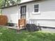 Cozy back entrance to home features an updated door, fresh exterior paint, and new steps at 4445 Kingsley Dr, Indianapolis, IN 46205