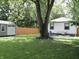 Expansive backyard with a storage shed, a wood fence, and patio offering privacy and functionality at 4445 Kingsley Dr, Indianapolis, IN 46205
