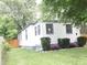 Charming home exterior featuring freshly landscaped yard, gray trim, and modern house numbers at 4445 Kingsley Dr, Indianapolis, IN 46205
