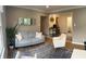 Cozy living room with a gray sofa, white chair, modern mirror and hardwood floors at 4445 Kingsley Dr, Indianapolis, IN 46205