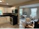 Charming kitchen flows into living room with white cabinets, granite countertops, and cozy seating area at 4445 Kingsley Dr, Indianapolis, IN 46205