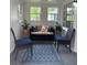 Relaxing sun room with two chairs, loveseat, large windows, and stylish blue rug at 4445 Kingsley Dr, Indianapolis, IN 46205