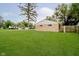 Expansive backyard featuring a lush green lawn, mature trees and a detached 2-car garage at 4514 Priscilla Ave, Indianapolis, IN 46226