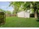 Large grassy backyard with a utility shed and privacy fence, perfect for outdoor activities at 4514 Priscilla Ave, Indianapolis, IN 46226