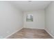 Neutral bedroom featuring new flooring, a fresh coat of light-grey paint and large window at 4514 Priscilla Ave, Indianapolis, IN 46226