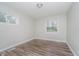 Bright bedroom featuring new flooring, a fresh coat of light-grey paint and abundant natural light at 4514 Priscilla Ave, Indianapolis, IN 46226
