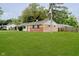 Well-kept front lawn with mature trees and a view of the home's exterior at 4514 Priscilla Ave, Indianapolis, IN 46226