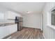 Bright kitchen featuring white cabinetry, stainless steel appliances and wood-look floors at 4514 Priscilla Ave, Indianapolis, IN 46226
