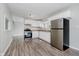 Kitchen with white cabinets, stainless steel appliances and wood-look floors at 4514 Priscilla Ave, Indianapolis, IN 46226