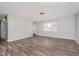 Bright living room featuring wood-look flooring, a large window, and neutral paint at 4514 Priscilla Ave, Indianapolis, IN 46226