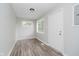 Bright living room featuring new flooring, a fresh coat of light-grey paint and abundant natural light at 4514 Priscilla Ave, Indianapolis, IN 46226