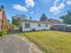View of the backyard with a detached garage and lush green grass at 4648 Brookville Rd, Indianapolis, IN 46201