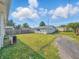 Spacious backyard with lush green grass and detached garage, ideal for outdoor enjoyment at 4648 Brookville Rd, Indianapolis, IN 46201