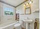 A bathroom featuring a sink, toilet, and a tub at 4648 Brookville Rd, Indianapolis, IN 46201