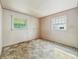 The empty bedroom is brightly lit by two windows at 4648 Brookville Rd, Indianapolis, IN 46201