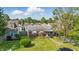 Charming brick home with a well-manicured lawn under a sunny, partly cloudy sky at 4648 Brookville Rd, Indianapolis, IN 46201