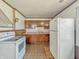A kitchen featuring wood cabinets, a white refrigerator, and a white stove at 4648 Brookville Rd, Indianapolis, IN 46201