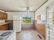 Bright, vintage kitchen featuring white appliances, tiled walls, and a window with a view at 4648 Brookville Rd, Indianapolis, IN 46201