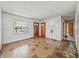 Spacious living room featuring a window, light walls, and a view to another room at 4648 Brookville Rd, Indianapolis, IN 46201