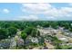 Urban aerial perspective reveals homes with nearby green spaces and city buildings in the distance under a bright sky at 517 N Alton Ave, Indianapolis, IN 46222
