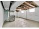 Exposed unfinished basement displaying concrete flooring, painted cinderblock walls, exposed ductwork, and a visible window at 517 N Alton Ave, Indianapolis, IN 46222