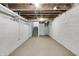 Unfinished basement with white concrete walls, exposed ceiling, and concrete flooring at 517 N Alton Ave, Indianapolis, IN 46222