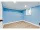 Finished basement with light blue walls, recessed lighting, and a window for natural light at 517 N Alton Ave, Indianapolis, IN 46222