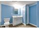 Bathroom featuring modern vanity, toilet, and storage cabinet at 517 N Alton Ave, Indianapolis, IN 46222