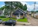 A quaint home displays its front facade, complete with a yard, landscaping, and nearby street at 517 N Alton Ave, Indianapolis, IN 46222