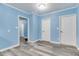 Inviting hallway with light blue walls, white trim, and stylish gray wood flooring at 517 N Alton Ave, Indianapolis, IN 46222