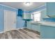This beautiful kitchen features light blue walls and cabinets, modern appliances, and stylish flooring at 517 N Alton Ave, Indianapolis, IN 46222