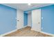 Room with light blue walls, white trim, and stylish gray wood flooring at 517 N Alton Ave, Indianapolis, IN 46222