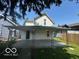 View of the back of the home featuring a spacious covered patio, perfect for outdoor entertaining at 521 N Alton Ave, Indianapolis, IN 46222