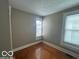 Bright bedroom with hardwood floors and two windows providing natural light at 521 N Alton Ave, Indianapolis, IN 46222
