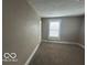 This bedroom features neutral walls and cozy carpet at 521 N Alton Ave, Indianapolis, IN 46222