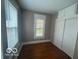 Comfortable bedroom featuring hardwood floors, built-in storage, and natural light from windows at 521 N Alton Ave, Indianapolis, IN 46222