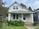 Charming two-story home featuring a covered front porch and a well-maintained front yard at 521 N Alton Ave, Indianapolis, IN 46222