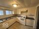 Functional kitchen with white cabinets, laminate countertops, and essential appliances at 521 N Alton Ave, Indianapolis, IN 46222