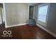 Cozy living room featuring hardwood floors, neutral paint, and a staircase at 521 N Alton Ave, Indianapolis, IN 46222