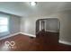 Inviting living room with hardwood floors and an open archway leading to other rooms at 521 N Alton Ave, Indianapolis, IN 46222