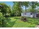 Spacious backyard with green grass and a detached garage at 524 S Arlington Ave, Indianapolis, IN 46219