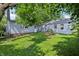 A view of the backyard, garage and back of the house in the summer at 524 S Arlington Ave, Indianapolis, IN 46219