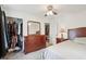Comfortable bedroom with a ceiling fan, carpet, and a wooden dresser with a mirror at 524 S Arlington Ave, Indianapolis, IN 46219