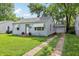 Charming single-story home features a well-manicured lawn, driveway, and tidy landscaping at 524 S Arlington Ave, Indianapolis, IN 46219